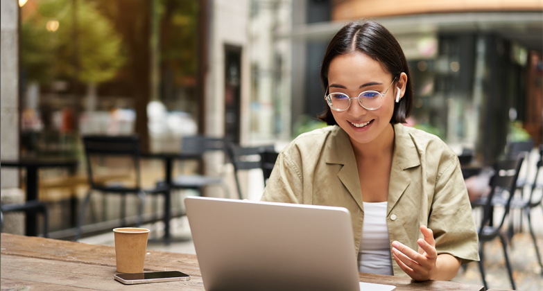 young woman using laptop computer in coffee shop