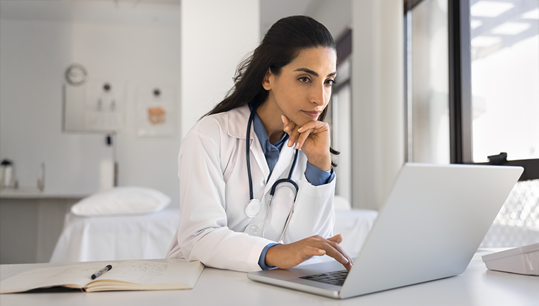 Female health care provider using laptop computer
