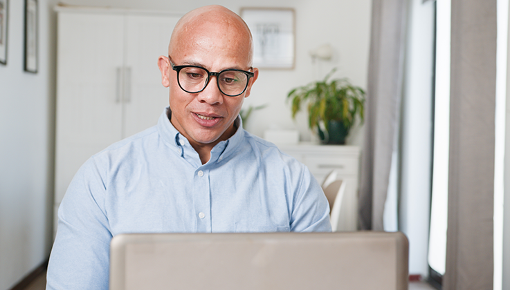 man at desk with laptop