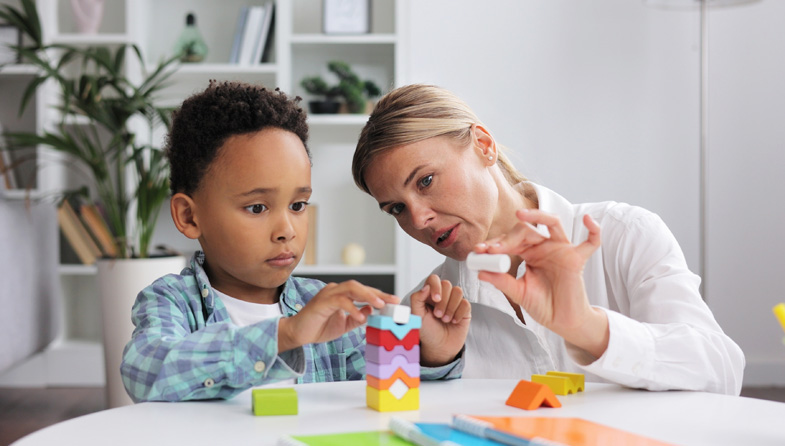 child and clinician working with blocks