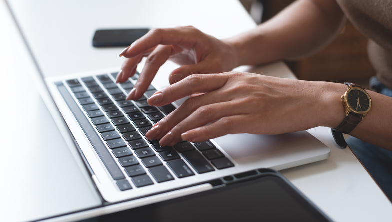 hands typing at computer