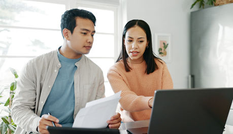 two people discussing information on computer