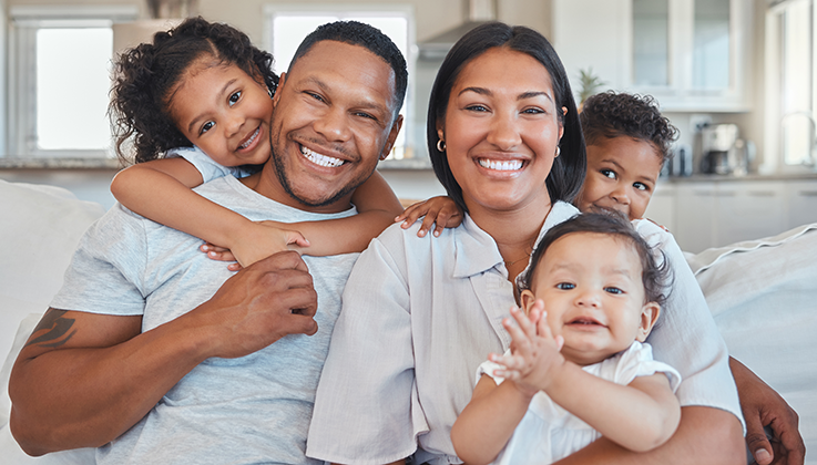 family sitting on couch having fun