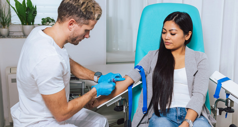 phlebotomist taking patient's blood