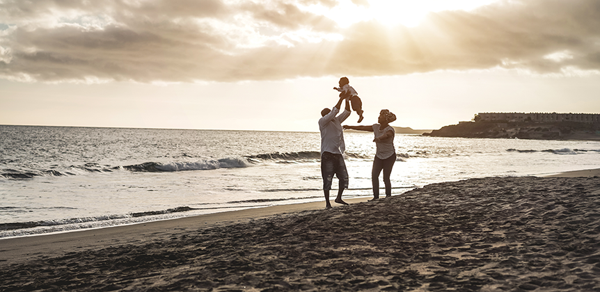 family playing on beach